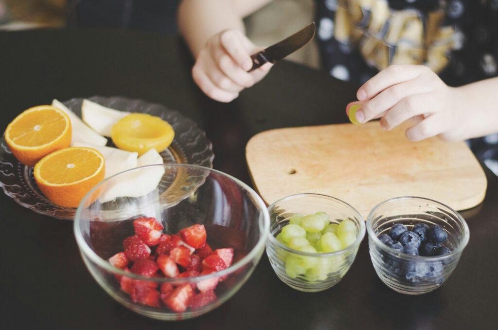 Kid’s preparing a fruit salad
