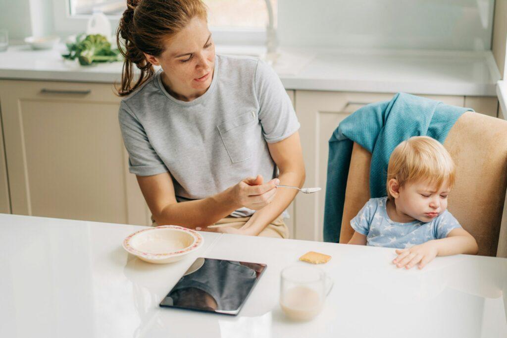 Little girl doesn't want to eat porridge. Child refusing to eat.