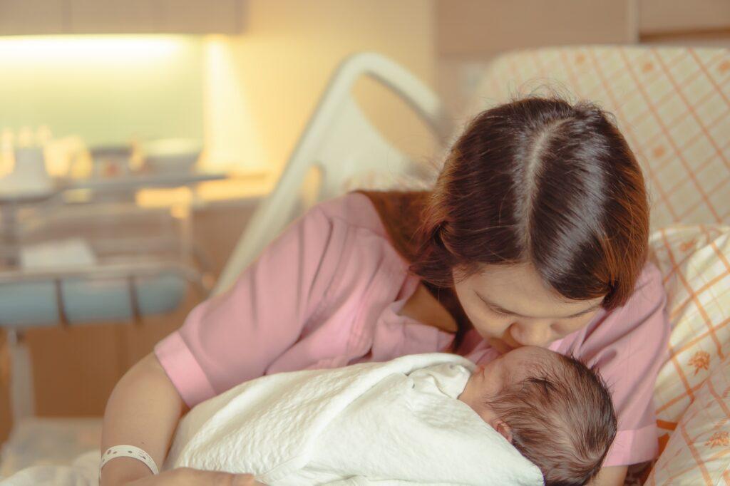 Newborn baby in mother's embrace, warmth, mother's love, baby