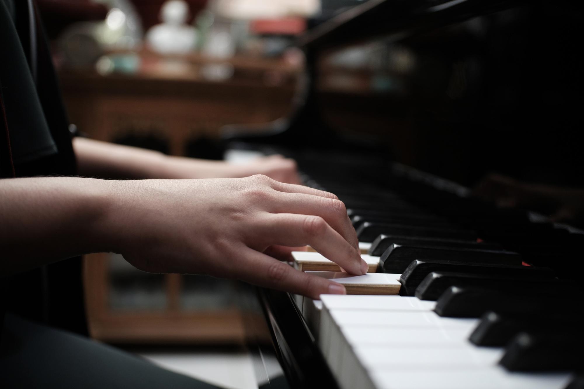 Beautiful asian girl learn to play piano.
