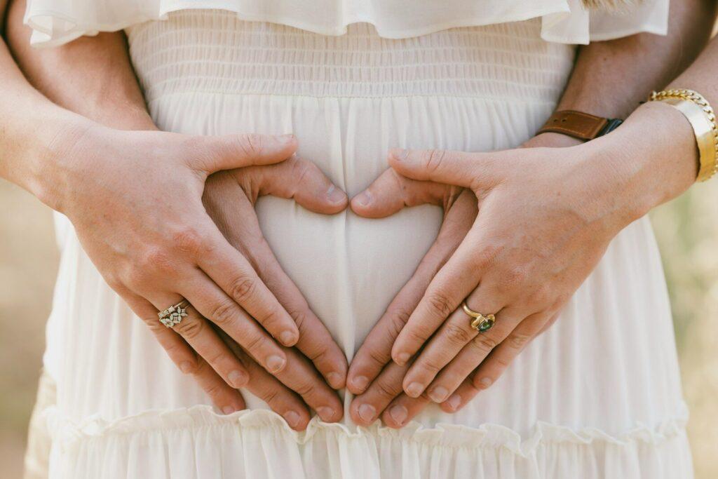 a woman holding her hands in the shape of a heart