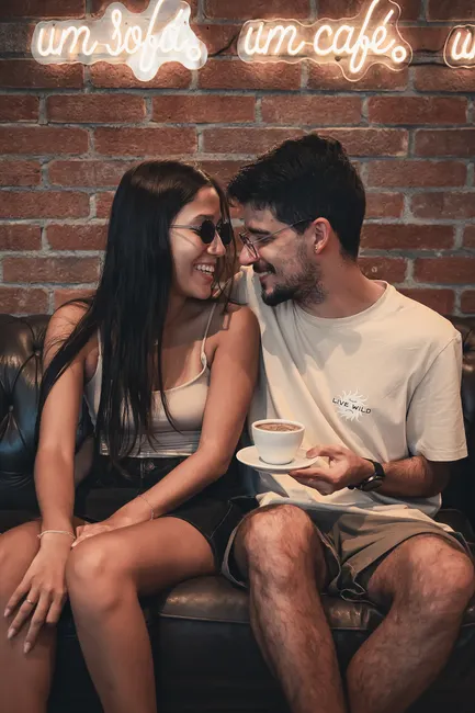 A couple sharing a moment on a sofa in a Rio de Janeiro cafe.