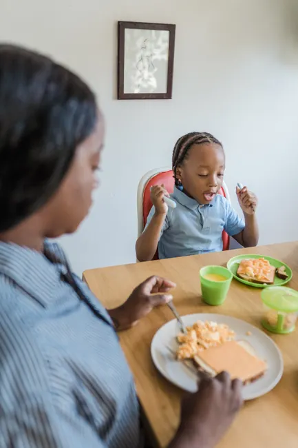 Mother and son sharing a healthy breakfast at home, fostering family bonding.